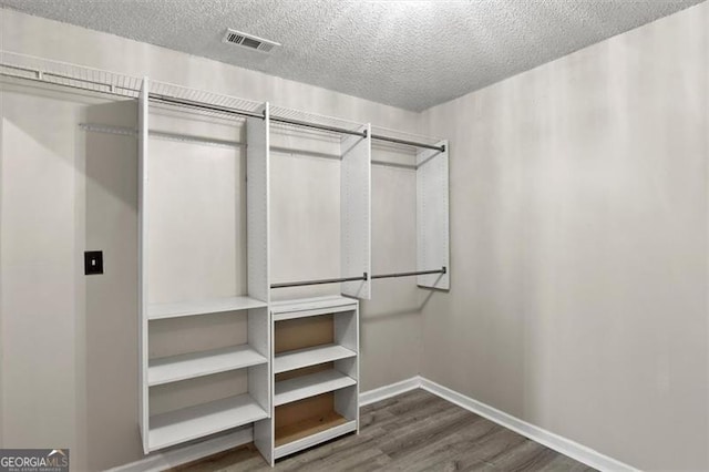 3385 Amhurst Pkwy, South Fulton, GA 30349 - walk in closet featuring dark wood-style flooring
