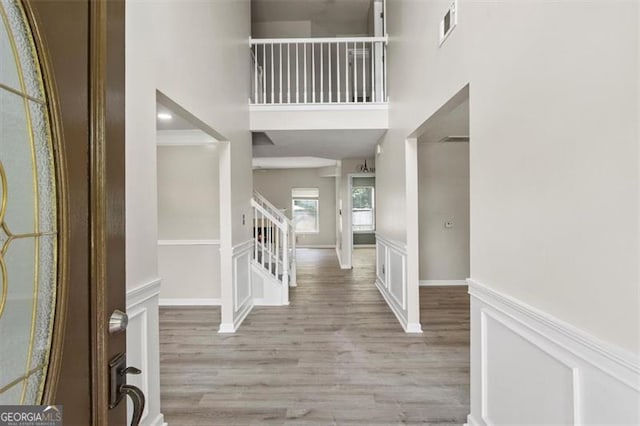 3385 Amhurst Pkwy, South Fulton, GA 30349 - entrance foyer with light wood-style floors, a towering ceiling, stairs, and baseboards