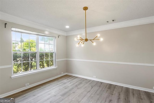 3385 Amhurst Pkwy, South Fulton, GA 30349 - empty room featuring a chandelier, wood finished floors, ornamental molding, healthy amount of natural light, and a textured ceiling