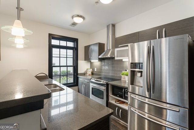 1300 Dekalb Ave NE Unit 711, Atlanta, GA 30307 - kitchen featuring stainless steel appliances, wall chimney exhaust hood, backsplash, modern cabinets, and decorative light fixtures