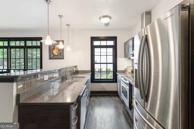 1300 Dekalb Ave NE Unit 711, Atlanta, GA 30307 - kitchen featuring appliances with stainless steel finishes, dark wood finished floors, plenty of natural light, and a peninsula