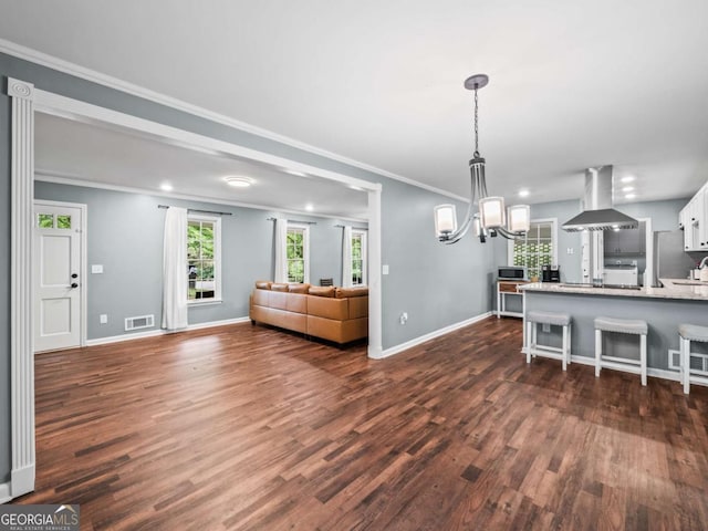 1488 Vine St NE, Gainesville, GA 30501 - living area with a chandelier, dark wood finished floors, baseboards, recessed lighting, and crown molding