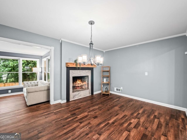 1488 Vine St NE, Gainesville, GA 30501 - unfurnished living room featuring wood finished floors, crown molding, a warm lit fireplace, a chandelier, and baseboards