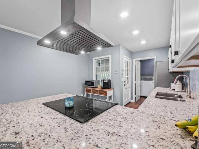 1488 Vine St NE, Gainesville, GA 30501 - kitchen with wall chimney exhaust hood, stainless steel microwave, a sink, light stone counters, and dark wood finished floors