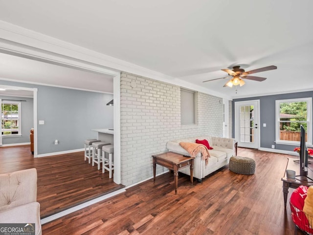 1488 Vine St NE, Gainesville, GA 30501 - living room with plenty of natural light, crown molding, wood finished floors, baseboards, and brick wall