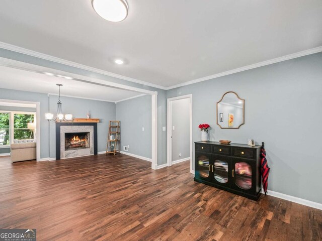 1488 Vine St NE, Gainesville, GA 30501 - living room with wood finished floors, baseboards, ornamental molding, a chandelier, and a warm lit fireplace