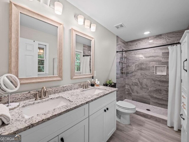 1488 Vine St NE, Gainesville, GA 30501 - full bathroom featuring double vanity, tiled shower, and toilet