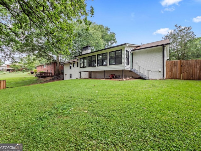1488 Vine St NE, Gainesville, GA 30501 - back of property with a sunroom, brick siding, and a chimney