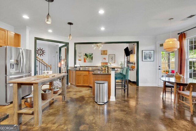 2295 Hemrick Rd, Cumming, GA 30041 - kitchen featuring stainless steel fridge, finished concrete floors, a kitchen bar, dark countertops, and a peninsula