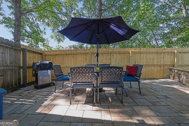 2295 Hemrick Rd, Cumming, GA 30041 - fenced backyard with outdoor dining space, a patio area, and area for grilling