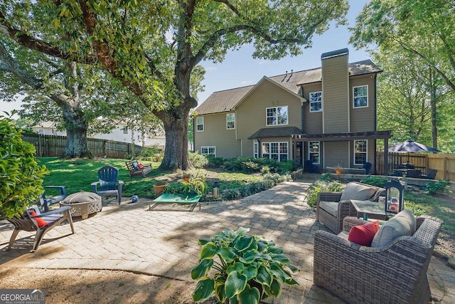2295 Hemrick Rd, Cumming, GA 30041 - back of house with an outdoor fire pit, a patio, a fenced backyard, and a chimney