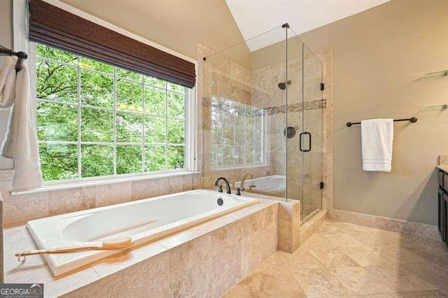 1206 Mountainside Trce NW, Kennesaw, GA 30152 - bathroom with vanity, a bath, a shower stall, baseboards, and vaulted ceiling