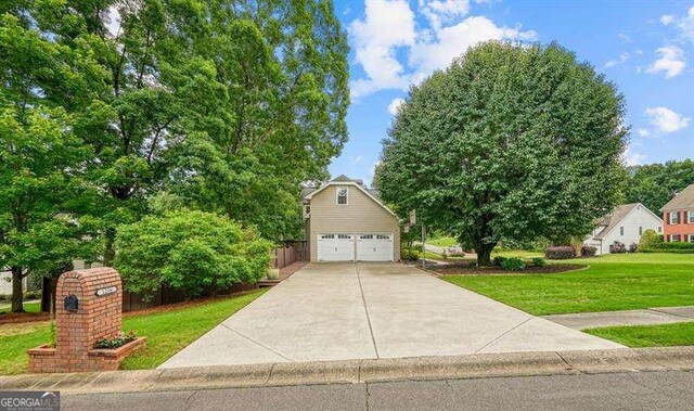 1206 Mountainside Trce NW, Kennesaw, GA 30152 - traditional-style house featuring a detached garage and a front yard