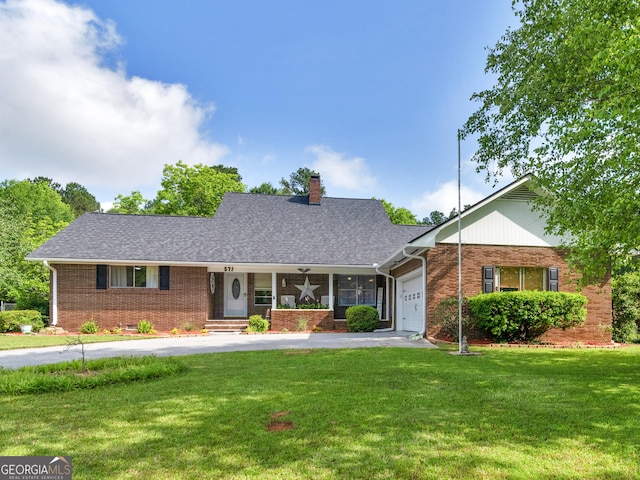 571 Swint Rd, Griffin, GA 30224 - view of front of home with brick siding, a garage, and a front lawn