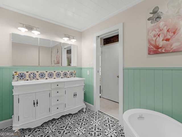 571 Swint Rd, Griffin, GA 30224 - bathroom with double vanity, a freestanding tub, wainscoting, crown molding, and tile patterned floors