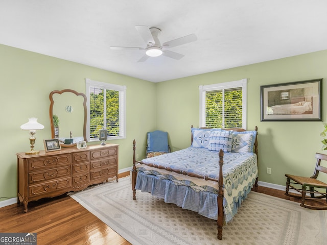 571 Swint Rd, Griffin, GA 30224 - bedroom featuring multiple windows, wood finished floors, baseboards, and a ceiling fan