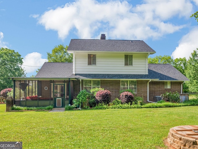 571 Swint Rd, Griffin, GA 30224 - back of house with a sunroom, brick siding, a yard, a chimney, and a shingled roof