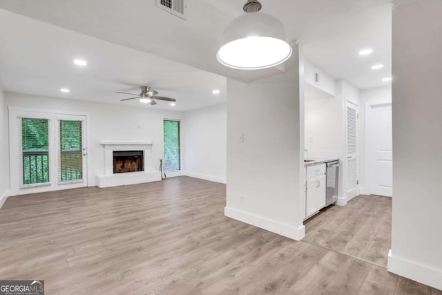 206 Tuxworth Cir, Decatur, GA 30033 - unfurnished living room featuring ceiling fan, light wood finished floors, baseboards, recessed lighting, and a brick fireplace