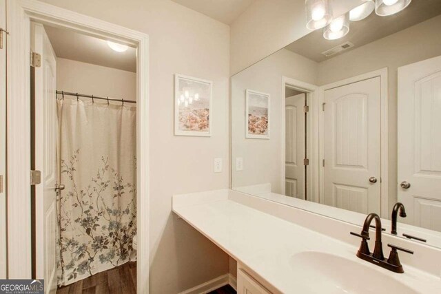 1300 Jefferson Walk Cir, Jefferson, GA 30549 - bathroom featuring vanity, wood finished floors, and a shower with curtain