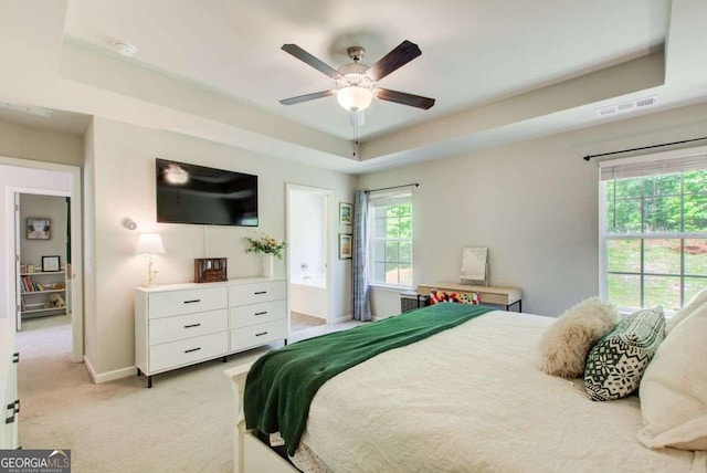 1300 Jefferson Walk Cir, Jefferson, GA 30549 - bedroom featuring light carpet, a raised ceiling, a ceiling fan, and ensuite bath