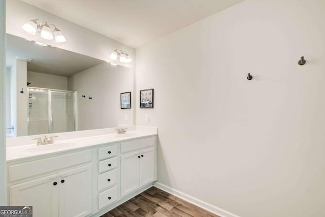 1300 Jefferson Walk Cir, Jefferson, GA 30549 - full bathroom featuring wood finished floors, double vanity, and a stall shower