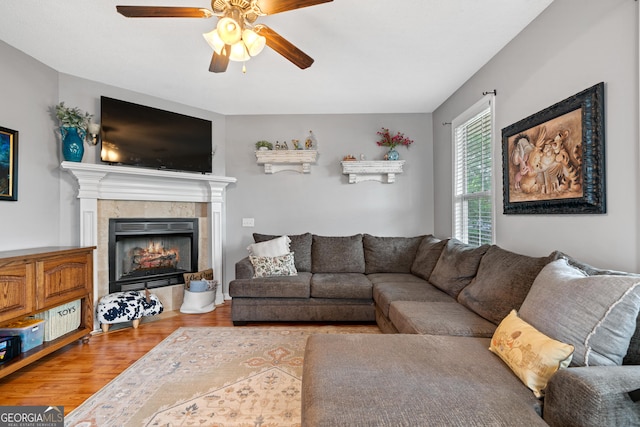 106 Thornton Dr, Bonaire, GA 31005 - living area with ceiling fan, a tile fireplace, and wood finished floors