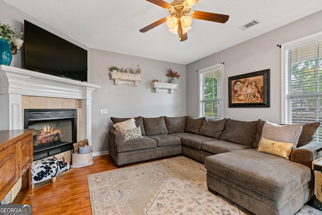 106 Thornton Dr, Bonaire, GA 31005 - living area featuring a ceiling fan, wood finished floors, a tile fireplace, and baseboards