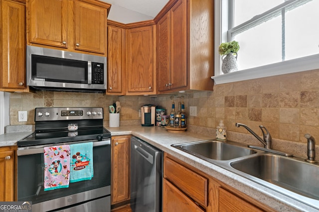 106 Thornton Dr, Bonaire, GA 31005 - kitchen with appliances with stainless steel finishes, a sink, light countertops, and tasteful backsplash