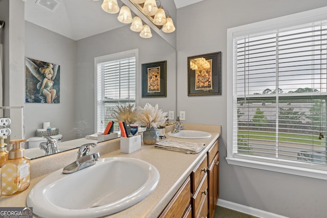 106 Thornton Dr, Bonaire, GA 31005 - bathroom featuring double vanity, a chandelier, and baseboards