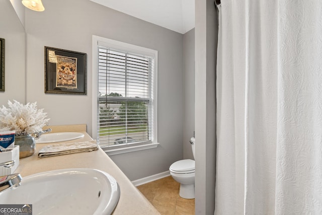 106 Thornton Dr, Bonaire, GA 31005 - full bathroom with double vanity, toilet, tile patterned floors, and baseboards