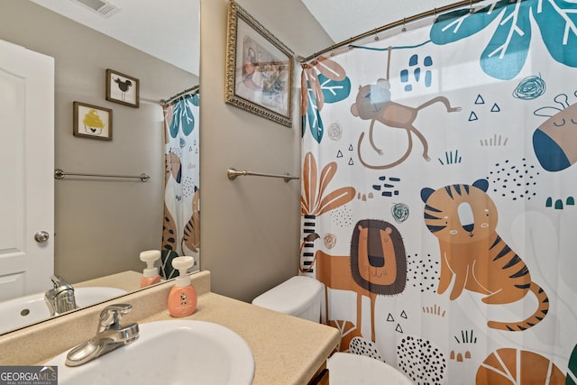 106 Thornton Dr, Bonaire, GA 31005 - bathroom featuring toilet, vanity, and a shower with shower curtain