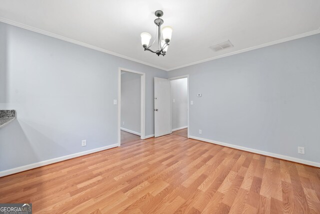 3047 Hudson Ct, Decatur, GA 30033 - spare room with a chandelier, light wood-style flooring, and ornamental molding