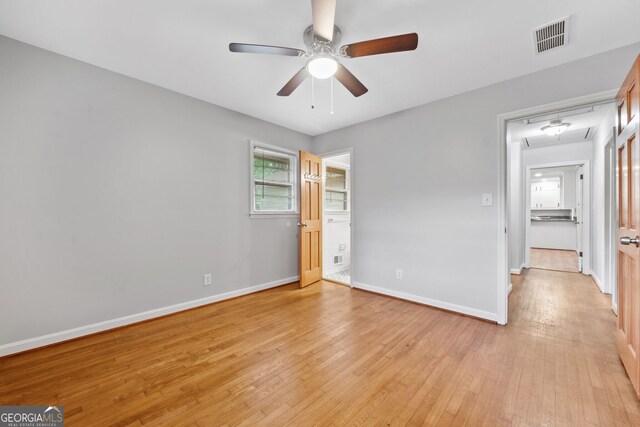 3047 Hudson Ct, Decatur, GA 30033 - unfurnished bedroom featuring attic access, light wood finished floors, ceiling fan, and ensuite bathroom