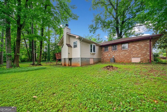 3047 Hudson Ct, Decatur, GA 30033 - rear view of house featuring a chimney and a lawn