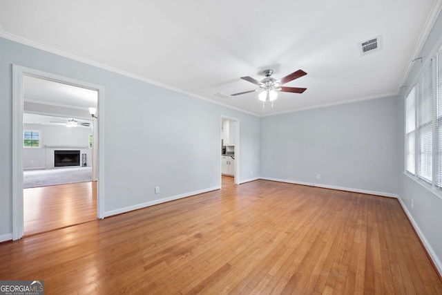 3047 Hudson Ct, Decatur, GA 30033 - empty room with a ceiling fan, light wood-type flooring, plenty of natural light, and ornamental molding