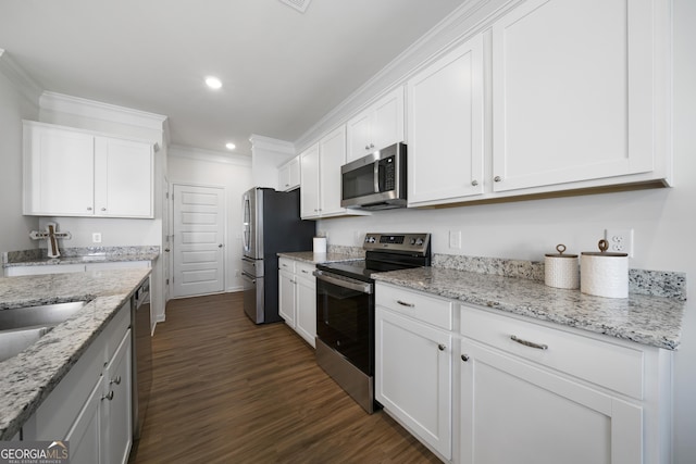 22 Mossy Oaks Ln NE, Rome, GA 30165 - kitchen with stainless steel appliances, white cabinets, dark wood-type flooring, recessed lighting, and crown molding
