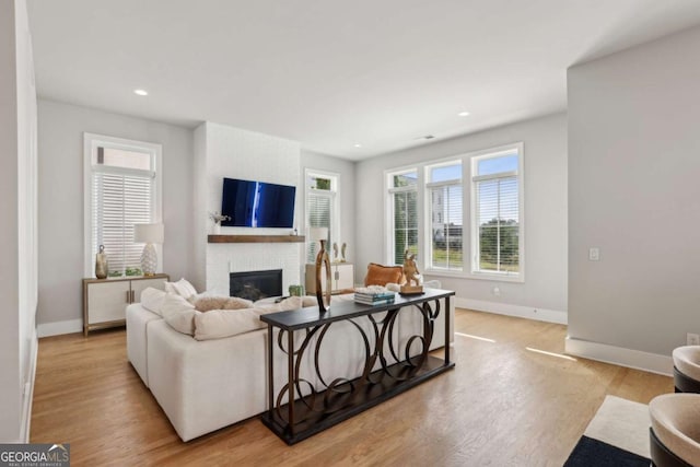 6815 Halcyon Way, Alpharetta, GA 30005 - living area with baseboards, a brick fireplace, light wood-style flooring, and recessed lighting