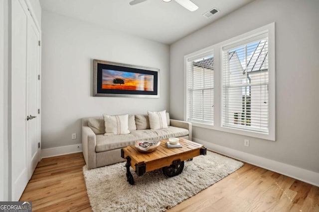 6815 Halcyon Way, Alpharetta, GA 30005 - living area with baseboards, light wood-style flooring, and a ceiling fan