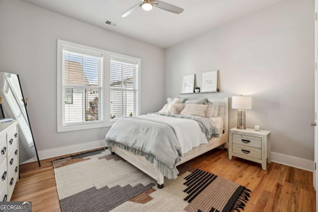 6815 Halcyon Way, Alpharetta, GA 30005 - bedroom featuring multiple windows, baseboards, light wood-type flooring, and ceiling fan