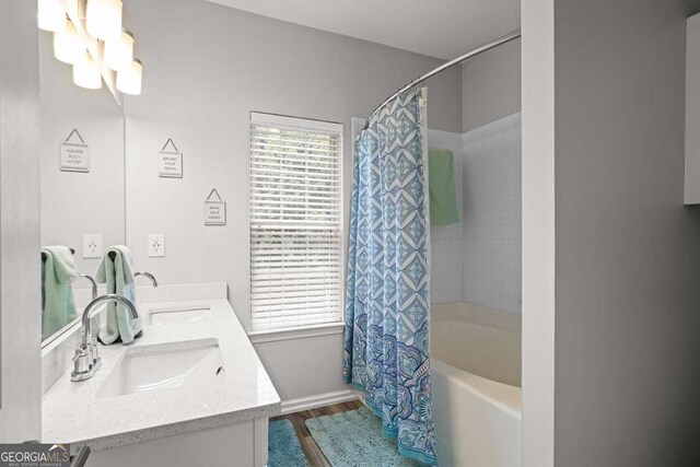 2061 Pinnacle Pointe Dr, Norcross, GA 30071 - full bathroom featuring wood finished floors, shower / tub combo, double vanity, and baseboards