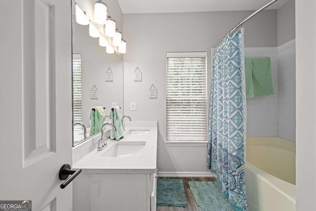 2061 Pinnacle Pointe Dr, Norcross, GA 30071 - full bathroom featuring shower / bath combo with shower curtain, wood finished floors, double vanity, and baseboards