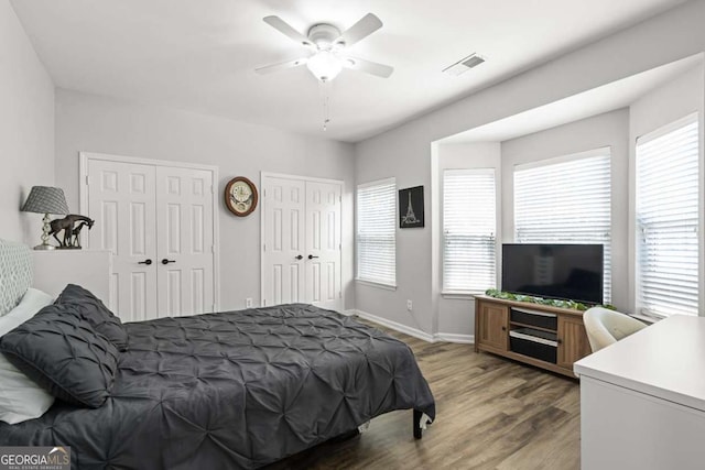 2061 Pinnacle Pointe Dr, Norcross, GA 30071 - bedroom featuring two closets, wood finished floors, baseboards, and ceiling fan