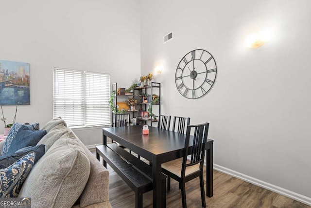 2061 Pinnacle Pointe Dr, Norcross, GA 30071 - dining area with baseboards, a high ceiling, and wood finished floors