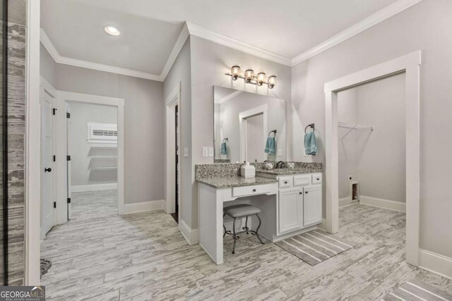 505 Parkview Dr, Milton, GA 30004 - bathroom featuring a spacious closet, vanity, crown molding, wood finished floors, and baseboards