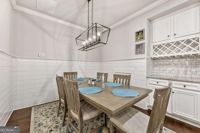 505 Parkview Dr, Milton, GA 30004 - dining space featuring ornamental molding, a wainscoted wall, a chandelier, and dark wood-style flooring