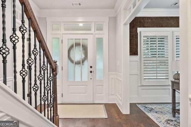 505 Parkview Dr, Milton, GA 30004 - foyer featuring a decorative wall, dark wood-style flooring, crown molding, a wainscoted wall, and healthy amount of natural light