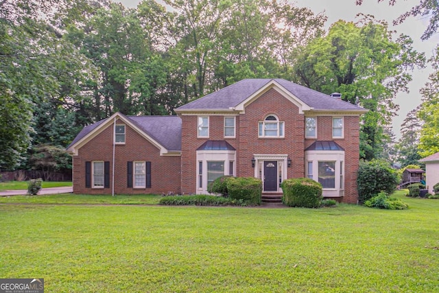 214 Jamestown Ave, Jonesboro, GA 30236 - view of front of home with a front lawn, brick siding, and view of scattered trees