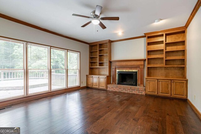 214 Jamestown Ave, Jonesboro, GA 30236 - unfurnished living room with dark wood finished floors, ornamental molding, a brick fireplace, a ceiling fan, and built in shelves
