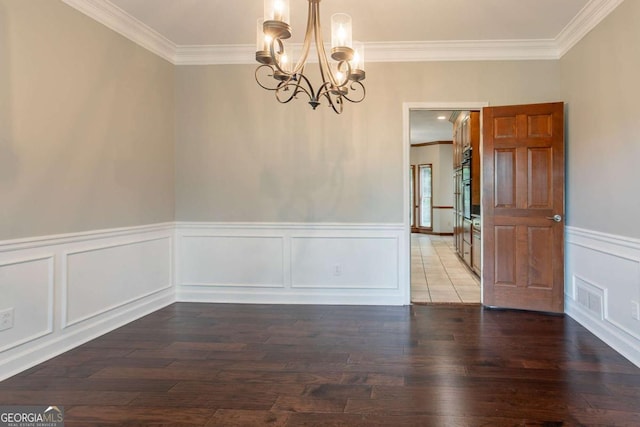 214 Jamestown Ave, Jonesboro, GA 30236 - unfurnished dining area featuring ornamental molding, a chandelier, hardwood / wood-style flooring, a decorative wall, and a wainscoted wall