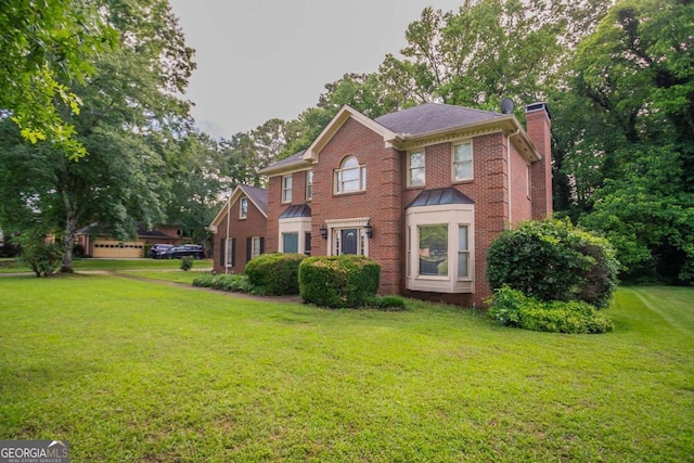 214 Jamestown Ave, Jonesboro, GA 30236 - view of front of property with a chimney, brick siding, and a front lawn